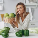 Smiling woman holding yellow tulips on cozy bed