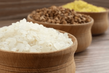 Three small wooden bowls with white, brown, yellow powders