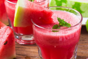 Red frozen drink with lime and mint