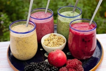 Colorful fruit smoothies in glass jars