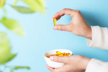 Hand holding blue puzzle piece over green pieces