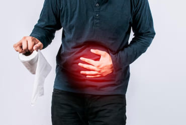 Woman holding stomach while sipping water