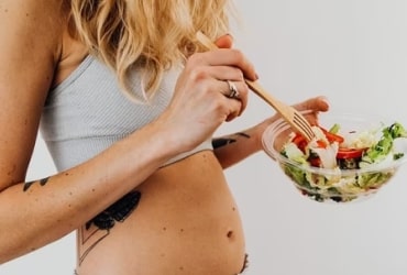 Hand applying lotion to arm in skincare routine