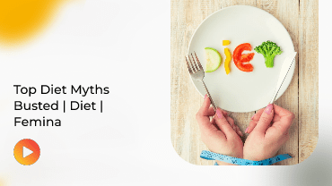 Hand holding plate of colorful veggie face