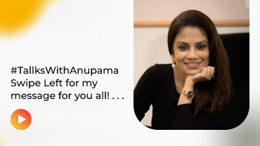 Smiling woman with long dark hair resting chin on hand