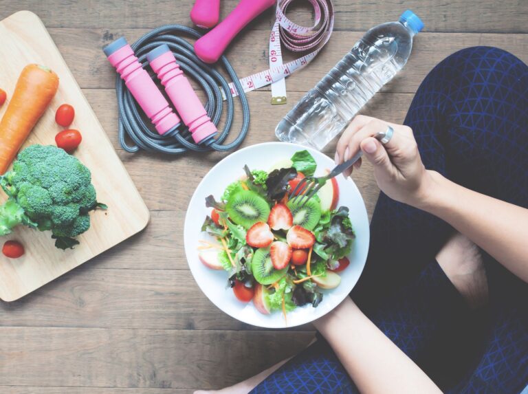 Ramen bowl held with chopsticks on table