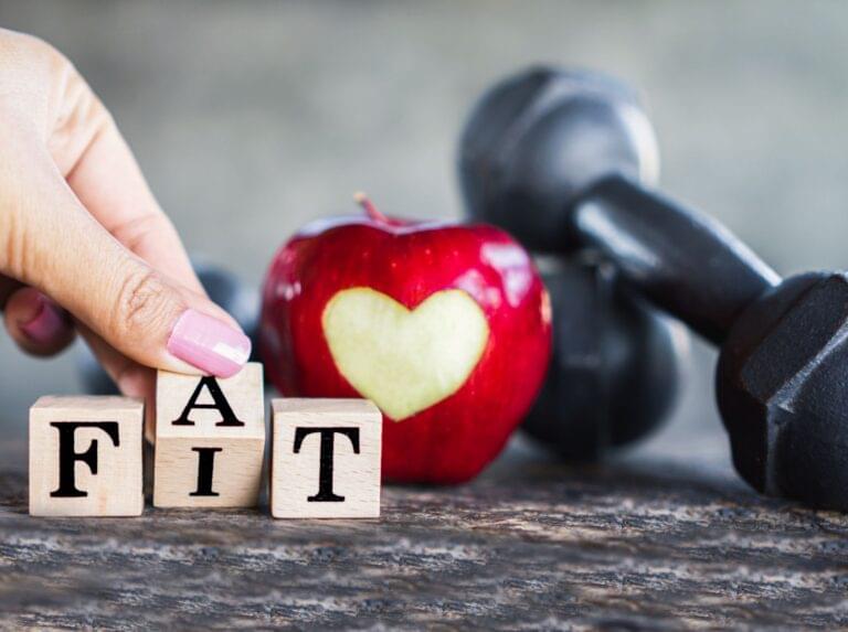 Stethoscope, red apple with heart cutout & HEALTH blocks