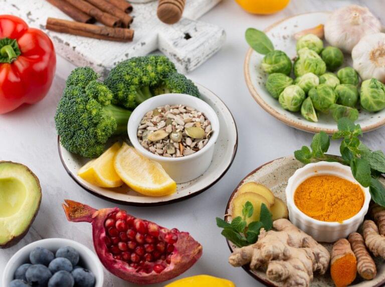 Fresh broccoli, lettuce, tomatoes, oranges on table